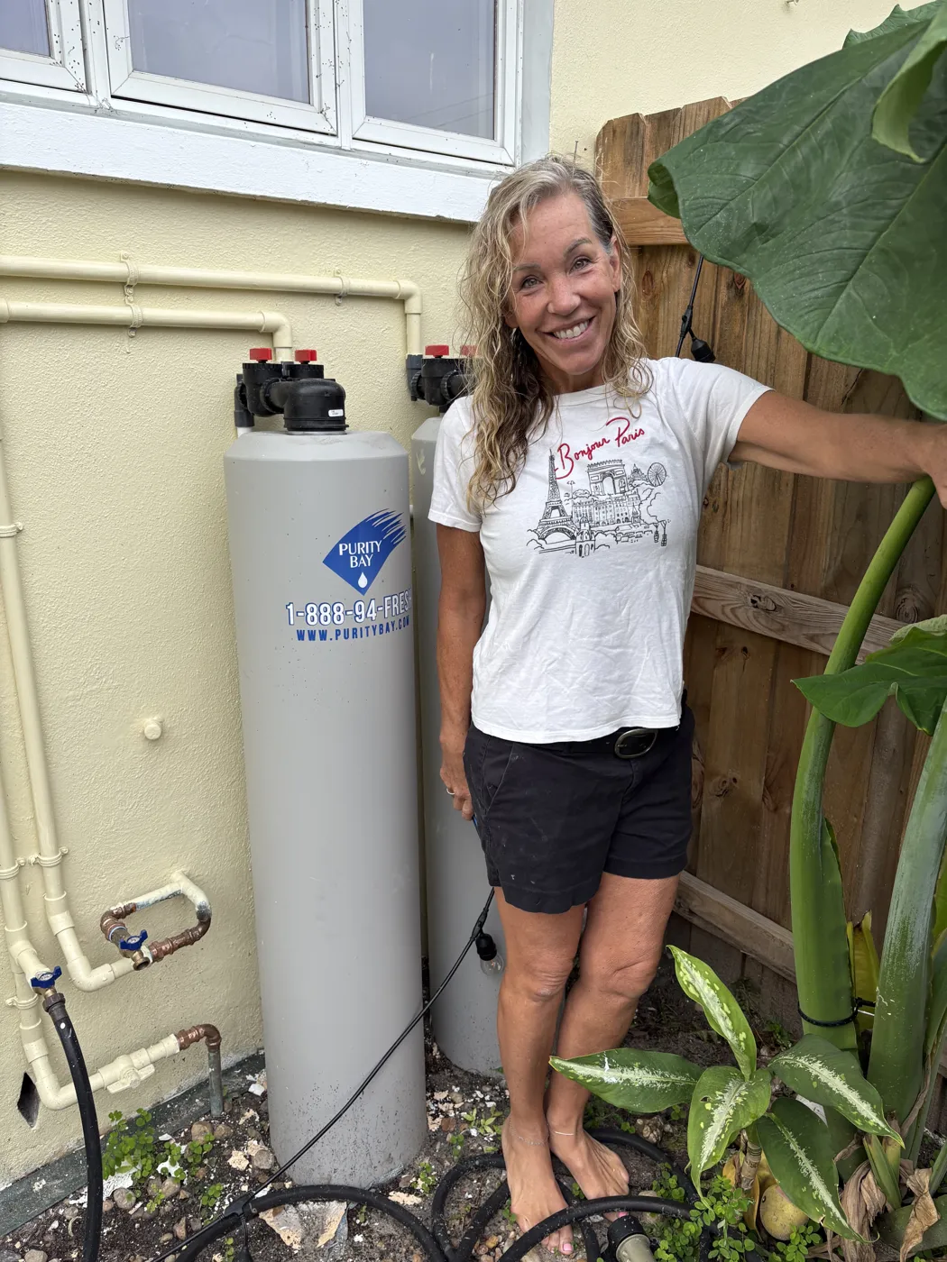 Clearwater homeowner beside her Purity Bay 10X Elite whole home water system