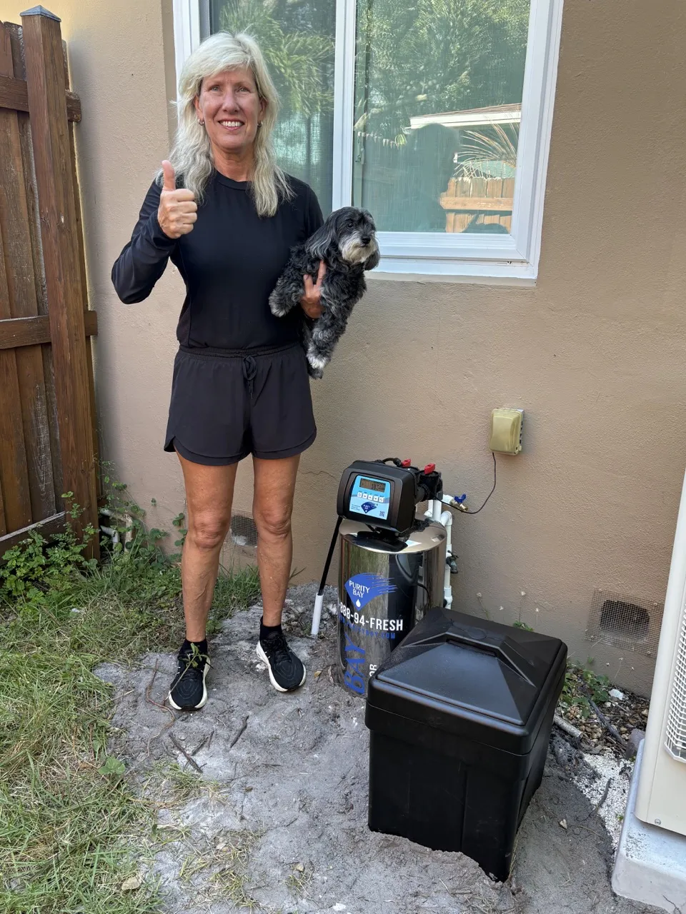 St. Petersburg homeowner beside her Purity Bay 10X Elite whole home water system