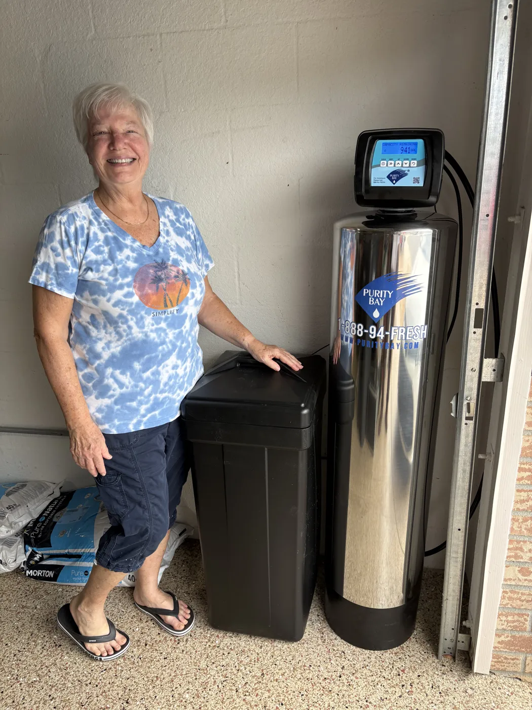 St. Petersburg homeowner beside her Purity Bay 10X Elite whole home water system