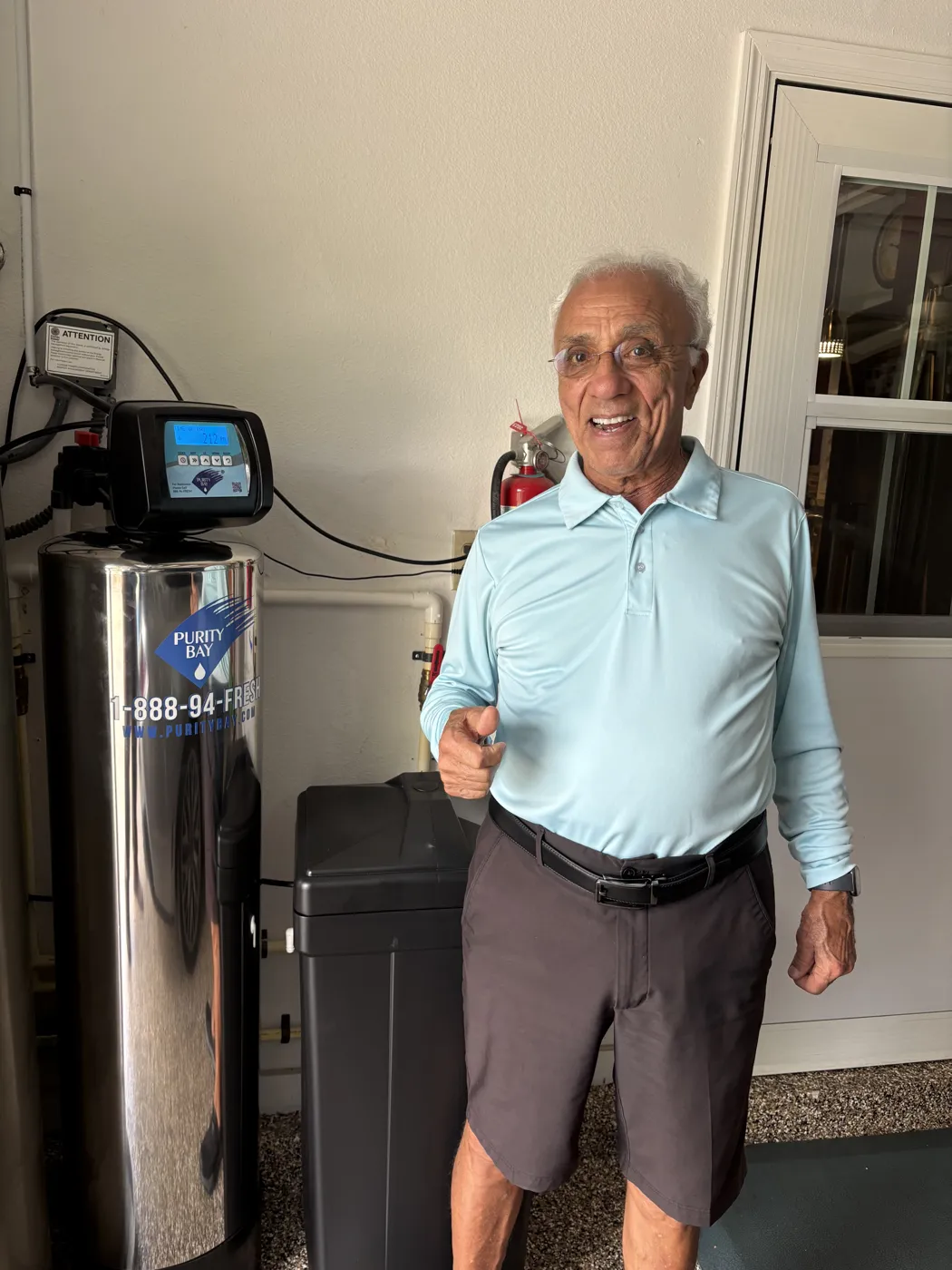 Seminole homeowner beside his Purity Bay 10X Elite whole home water system