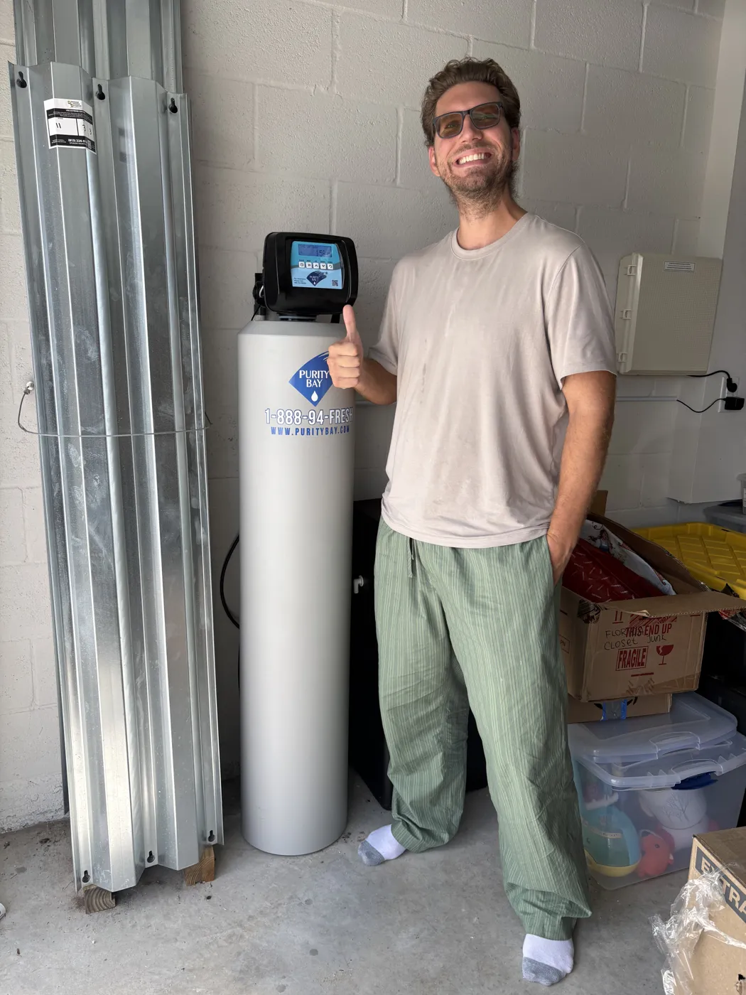 Bradenton homeowner beside his Purity Bay 5X Pro whole home water system