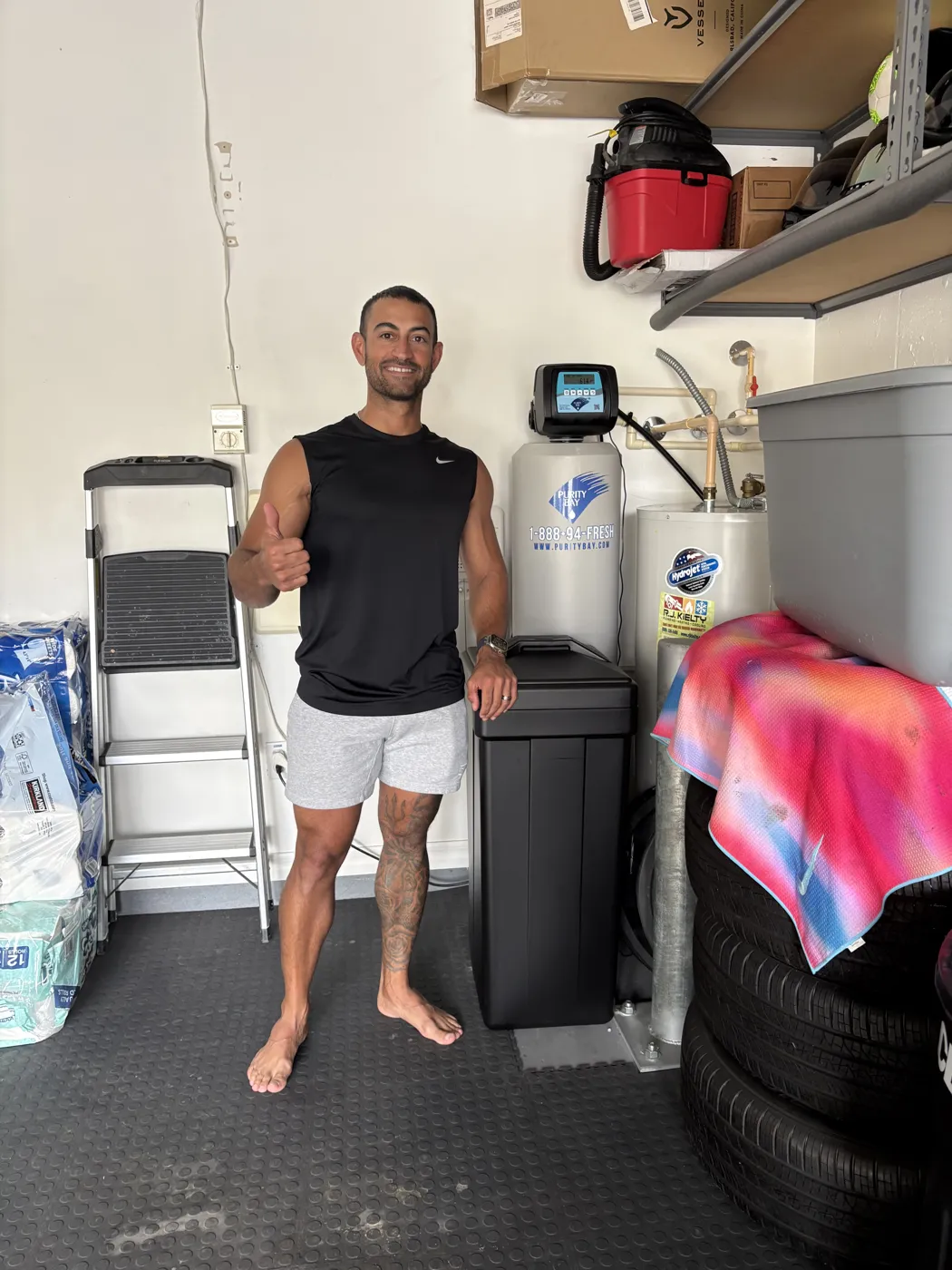 Clearwater homeowner beside his Purity Bay 5X Pro whole home water system