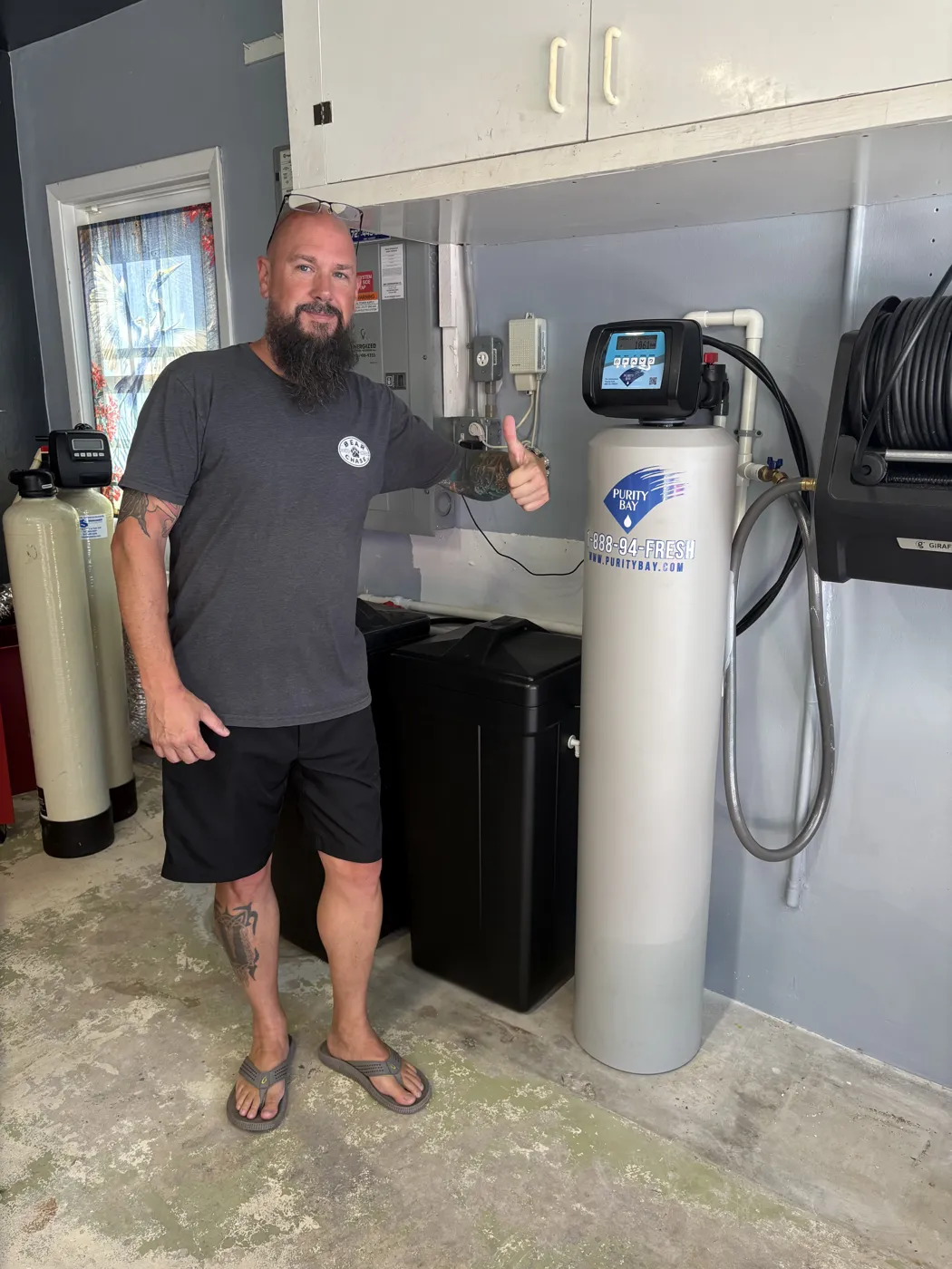 Clearwater homeowner beside his Purity Bay 5X Pro whole home water system