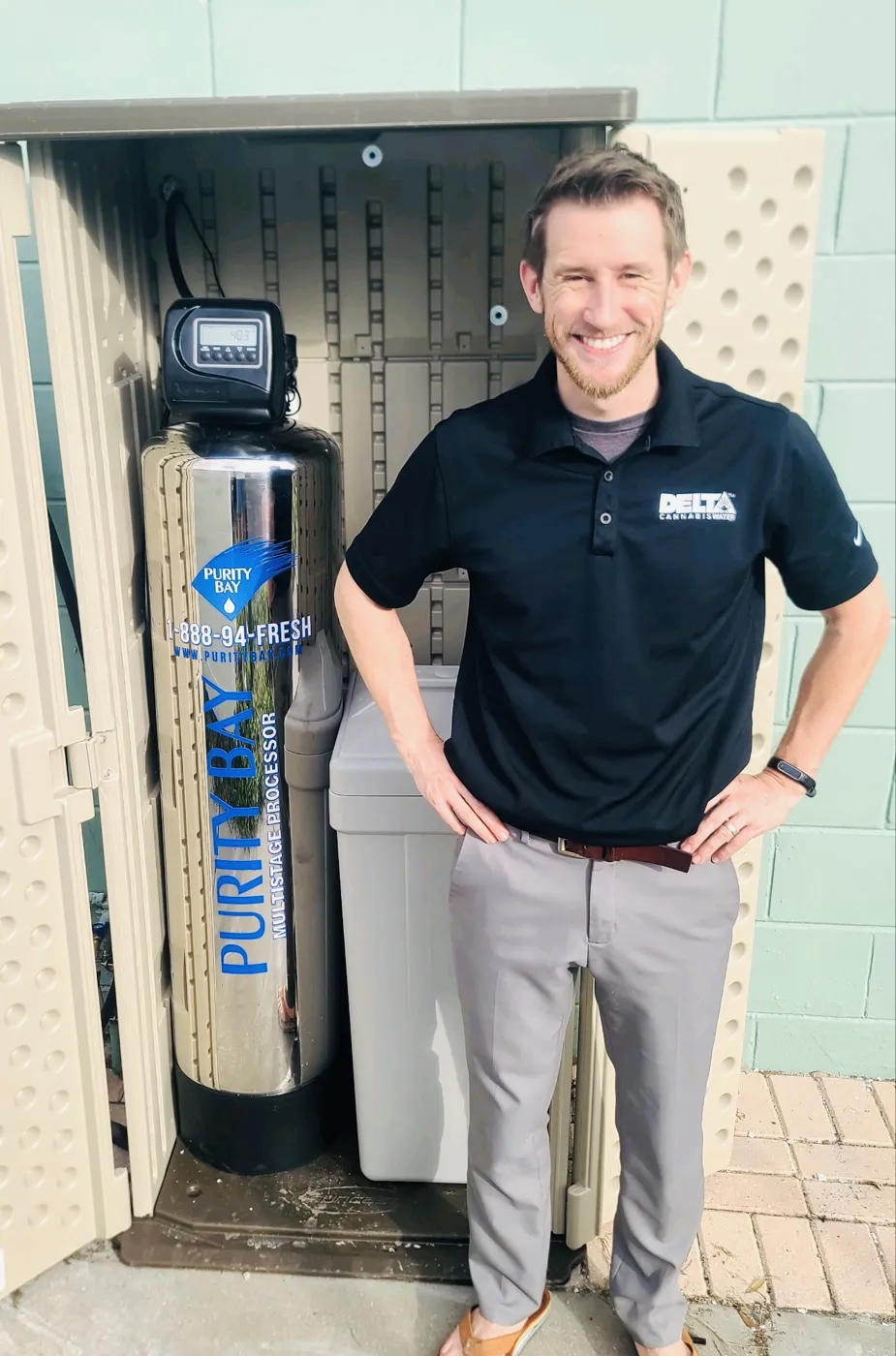Tampa homeowner beside their Purity Bay 10X Elite whole home water system