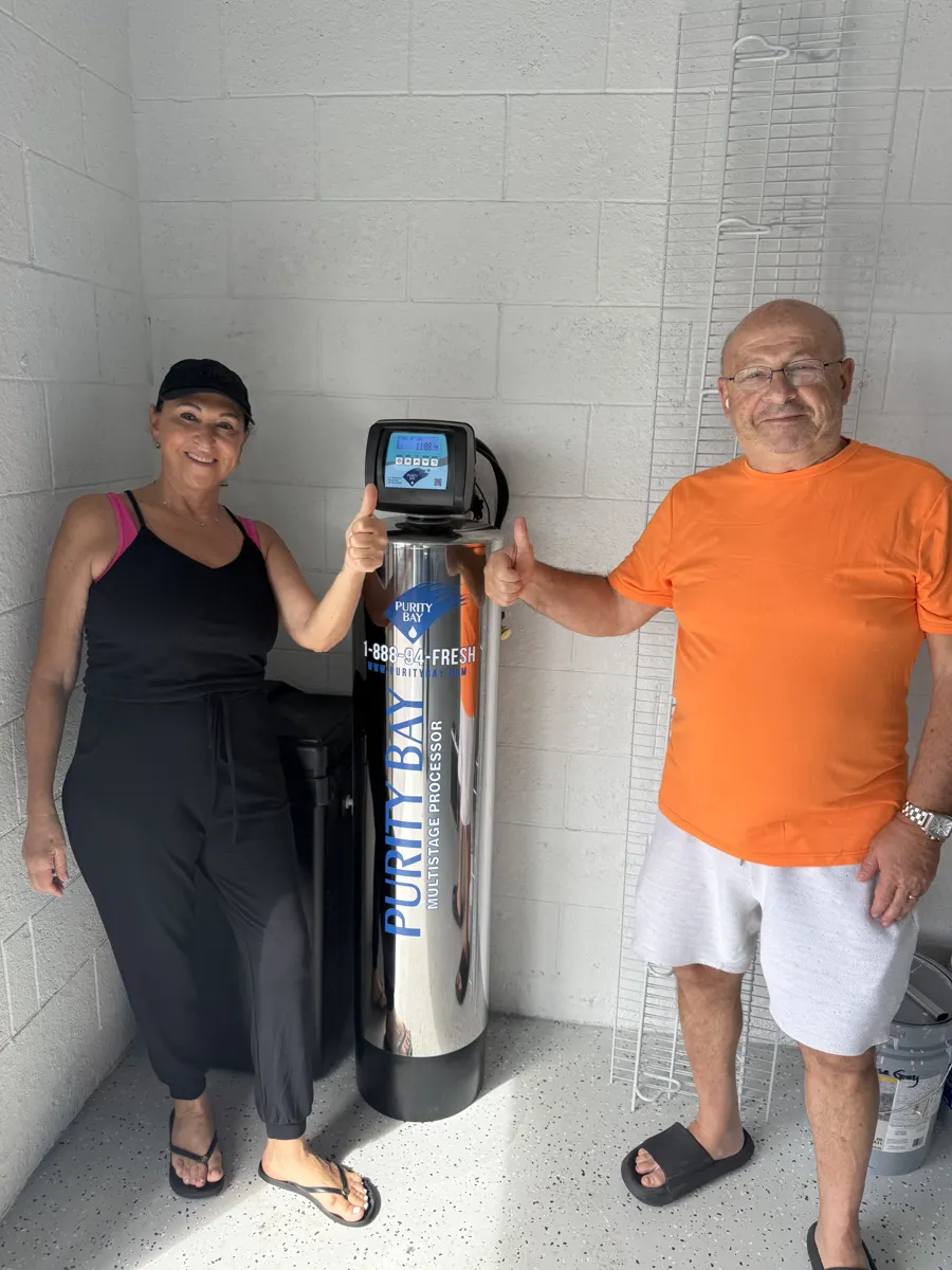 Bradenton homeowner beside their Purity Bay 10X Elite whole home water system