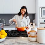 Happy woman cooking in kitchen